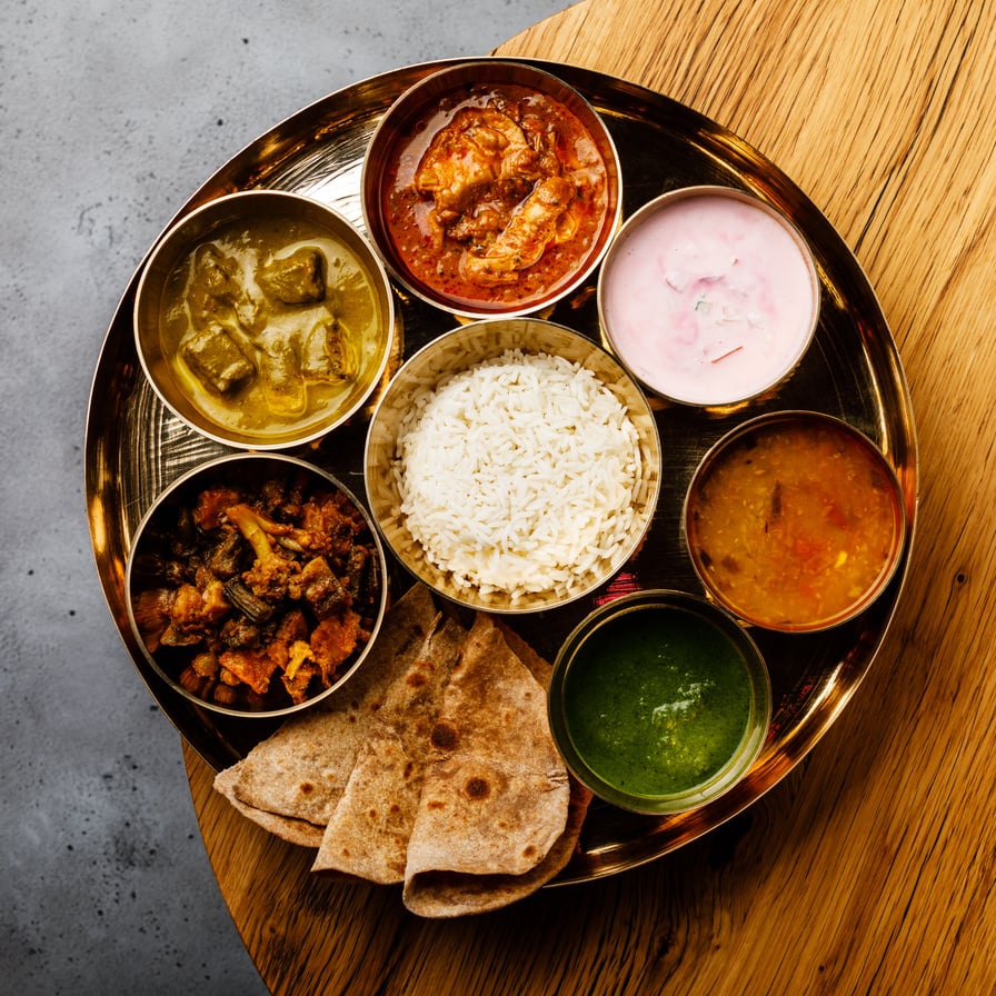 Indian food Thali Indian-style meal with chicken meat on wooden table